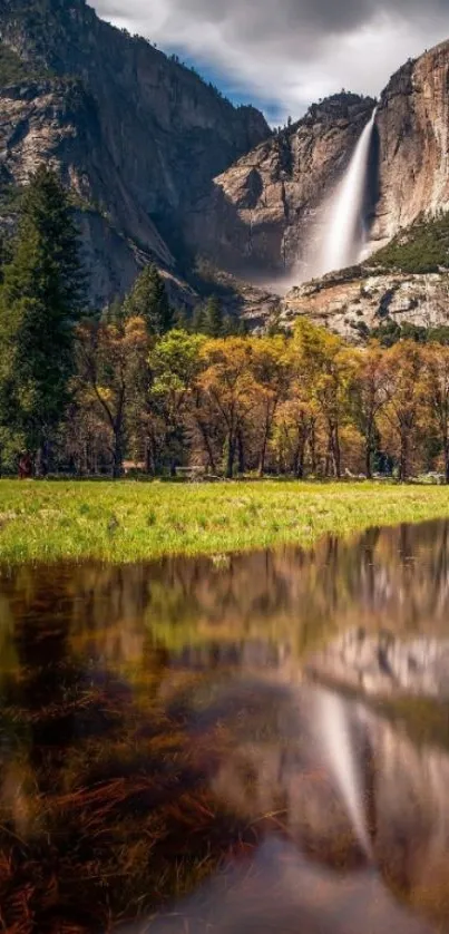 Yosemite waterfall reflecting in serene waters with lush greenery.