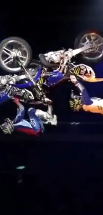 Dirt bike performing aerial stunt in darkness.