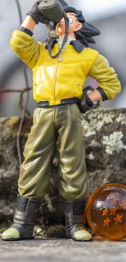 Anime figure in yellow jacket with dragon ball toy.