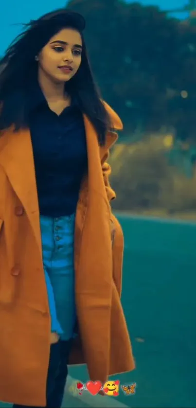 Woman in orange coat walking on street in autumn.