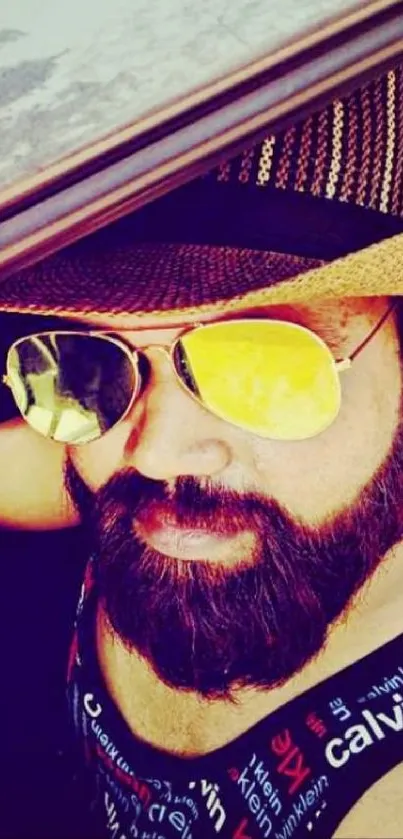 Stylish bearded man wearing shades and a hat.