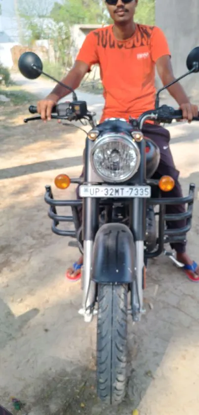 A young man riding a motorcycle on a sunny day.