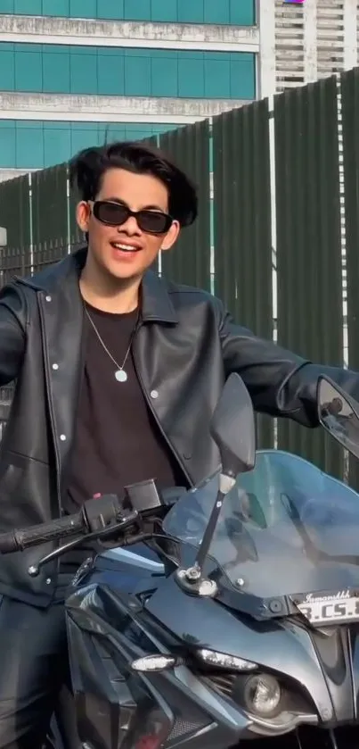 Cool biker in black leather jacket with motorcycle.