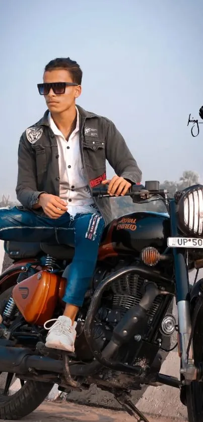 Fashionable biker seated on a classic motorcycle against urban backdrop.