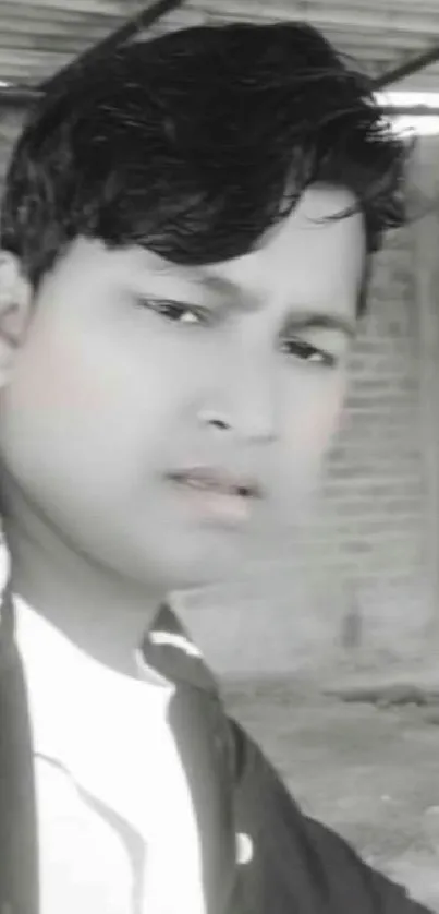 Black and white portrait of a young person in an urban setting.