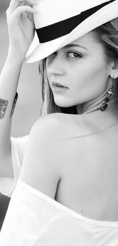 Black and white portrait of a stylish woman wearing a hat.