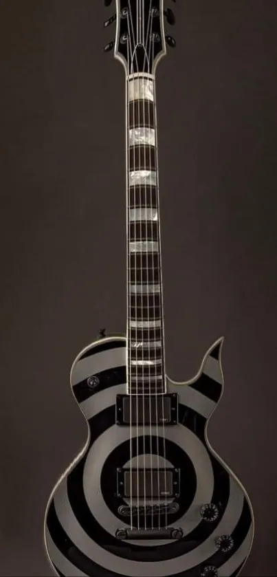 Stylish black guitar with spiral patterns on a dark background.