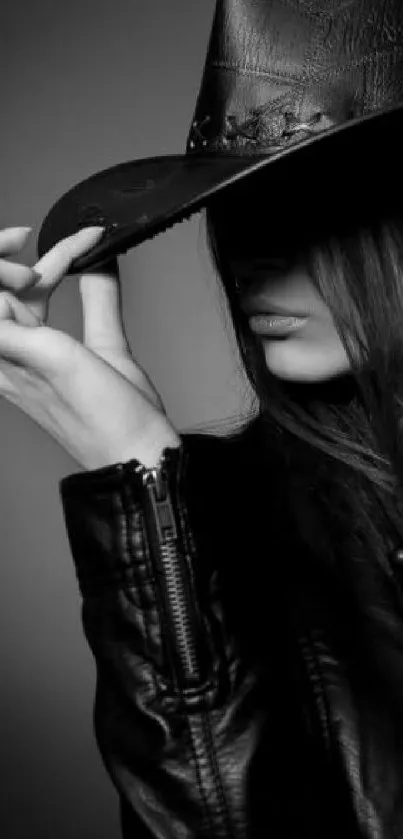 Mysterious woman in black leather and hat in monochrome.