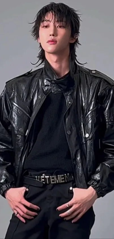 Stylish person in a black leather jacket posing confidently.