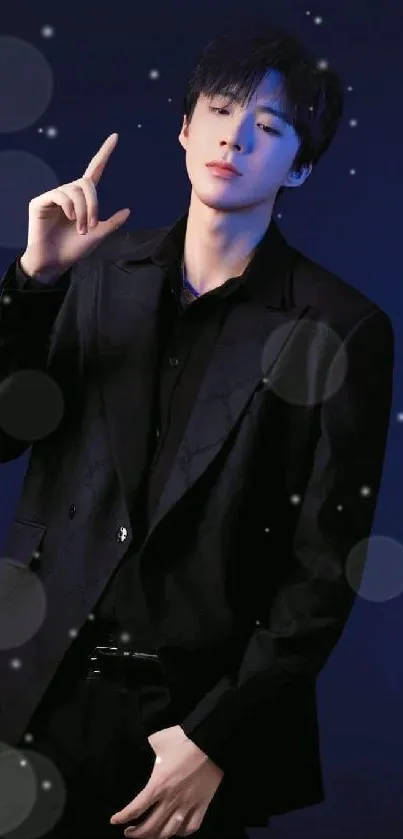 Person wearing a stylish black suit against a dark blue background.