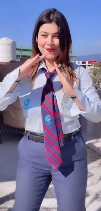 Person in a stylish blue outfit with tie posing outdoors.