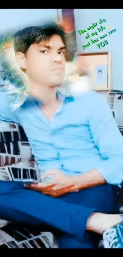 Stylish individual in blue shirt sitting on a patterned sofa.