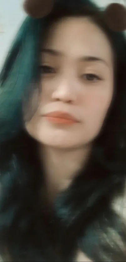 Blurred teal portrait of a woman with long hair.