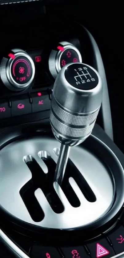 Car gear shift with metallic and red accents, sleek design.