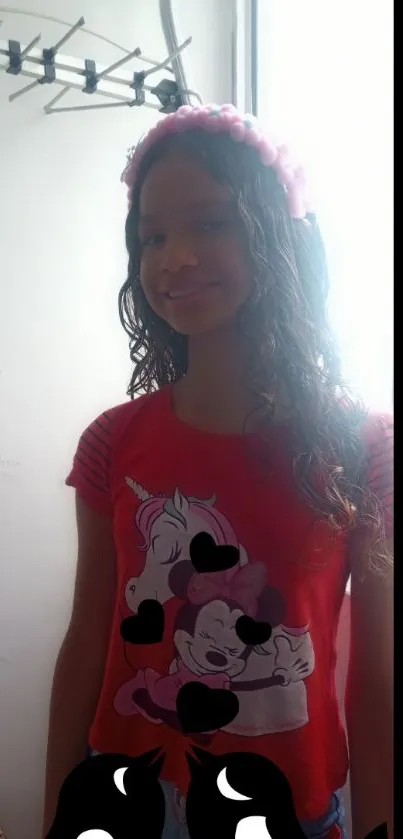 Young girl in a red cartoon T-shirt with vibrant style and playful elements.