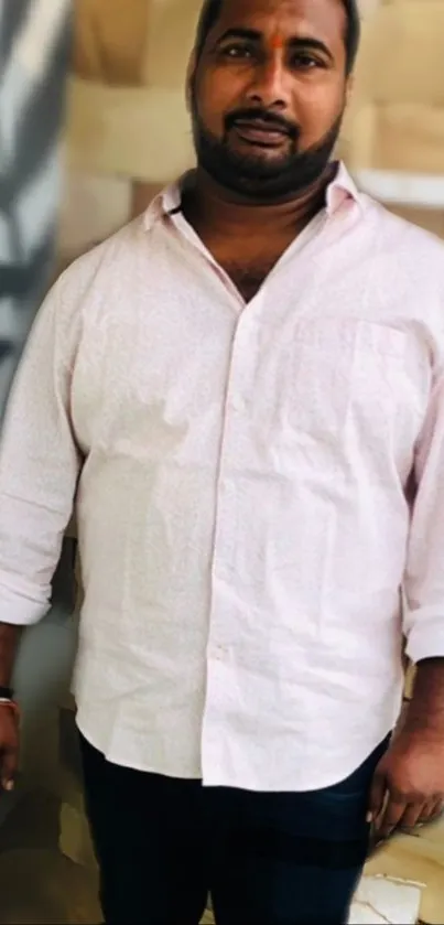 Man in light pink shirt with abstract background.