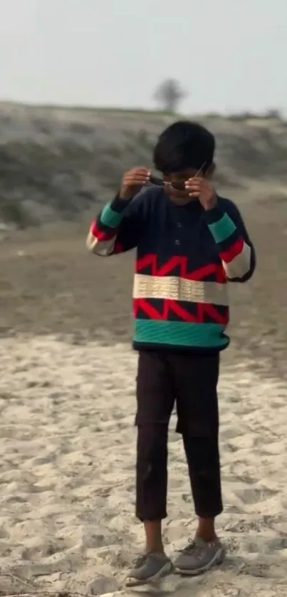 Child wearing stylish clothes at the beach.