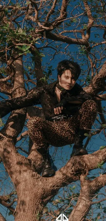 Stylish individual perched in a tree with a vivid blue sky backdrop.