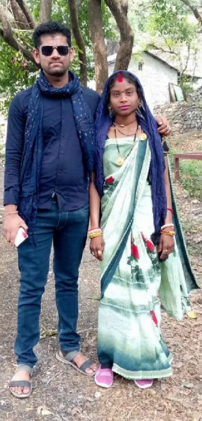 Couple in traditional attire outdoors.