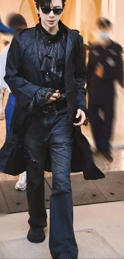 Person in stylish dark outfit walking with confidence.