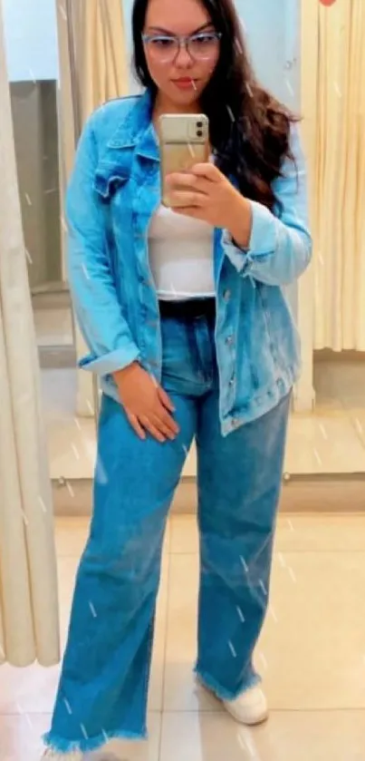 Mirror selfie showcasing denim fashion in a stylish blue outfit.