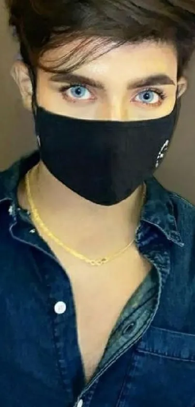 Fashionable masked person in denim shirt portrait.