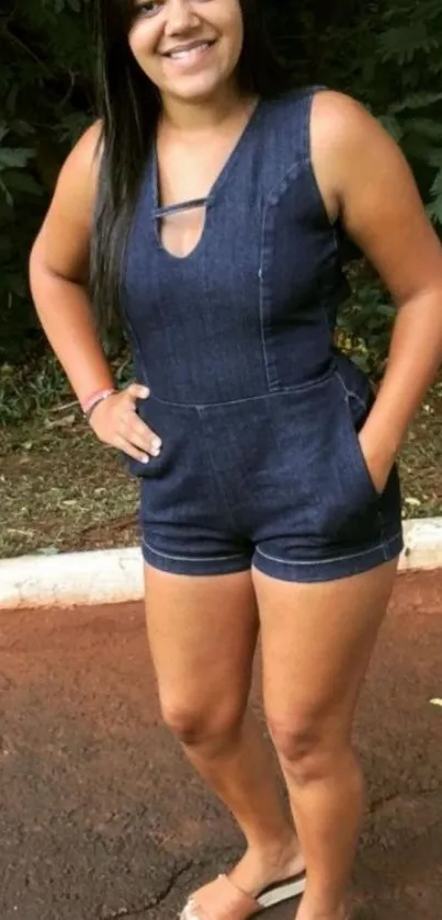 Woman wearing denim outfit with nature backdrop.