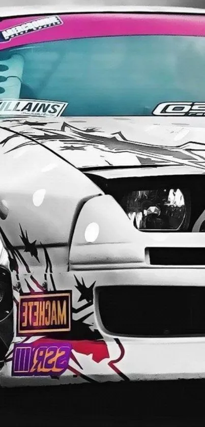 Stylish white drift car with graffiti design on hood.