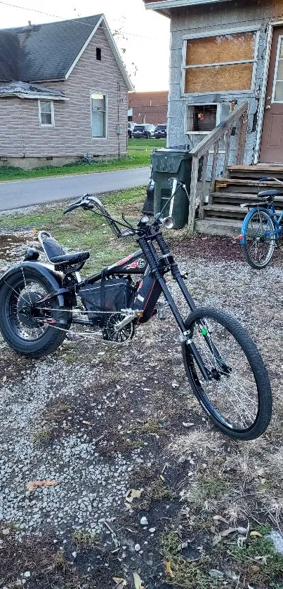 Stylish black electric bike parked by vintage house.