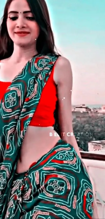 Woman in vibrant red and green ethnic attire on a rooftop.