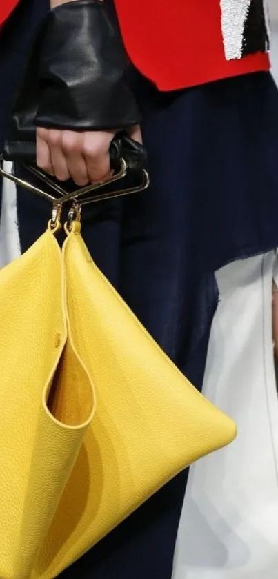 Mobile wallpaper with a stylish yellow handbag and modern attire.