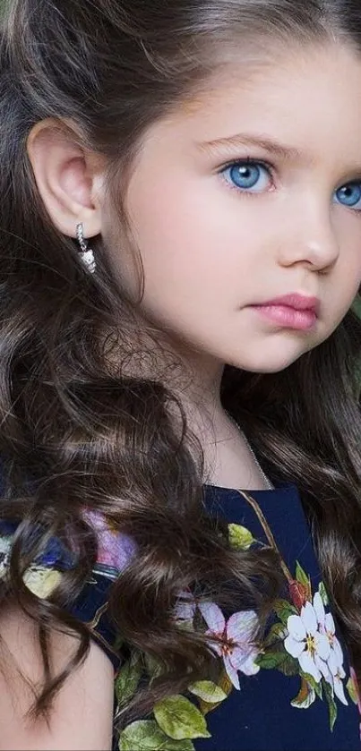 Portrait of a young girl with floral dress against a dark green background.