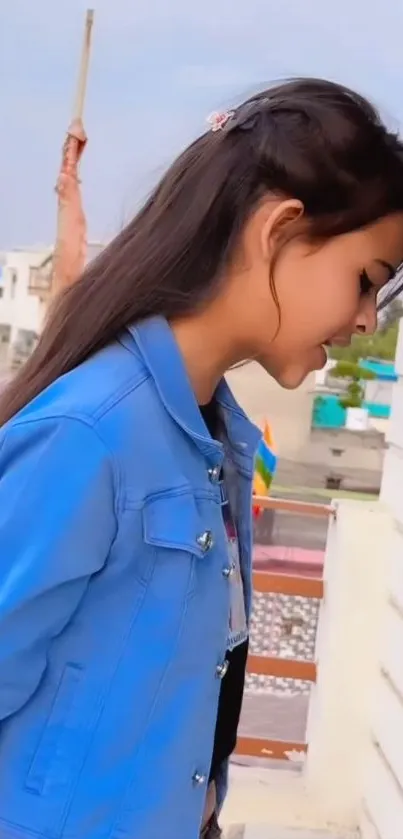 Girl in blue jacket with urban background.