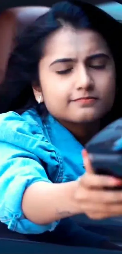 Girl in denim jacket with phone inside car.