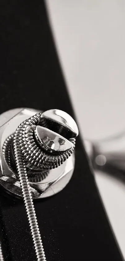 Close-up of a guitar with shining metal strings and black body.