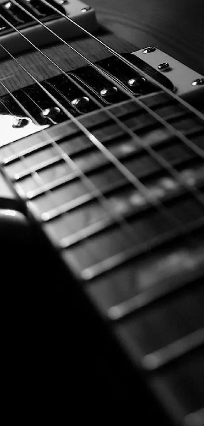 Close-up of electric guitar strings in black and white.