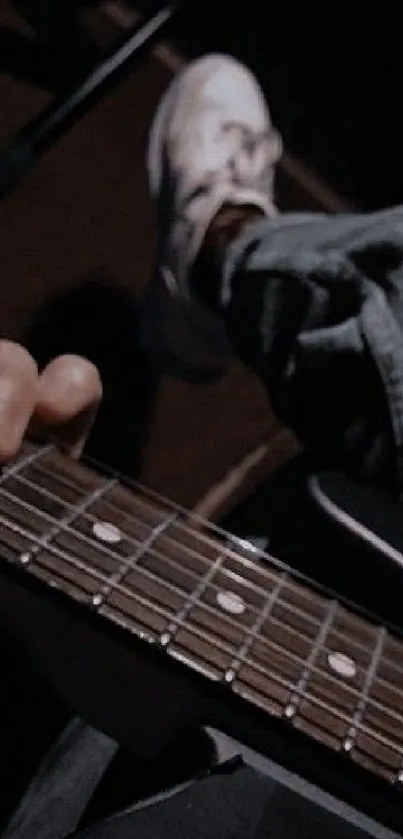 Guitar player with ripped jeans in a stylish pose.