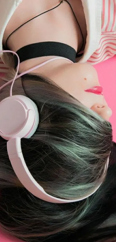 Stylish over-ear headphones lying on a bright pink background.