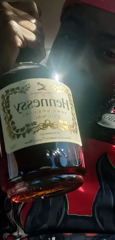 Person holding a Hennessy bottle with headphones, showcasing a bold red and black theme.