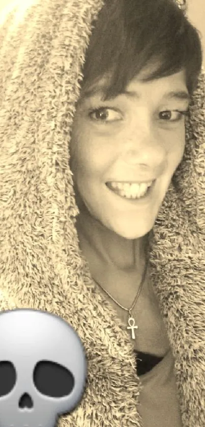 Person in hoodie with skull emoji overlay.