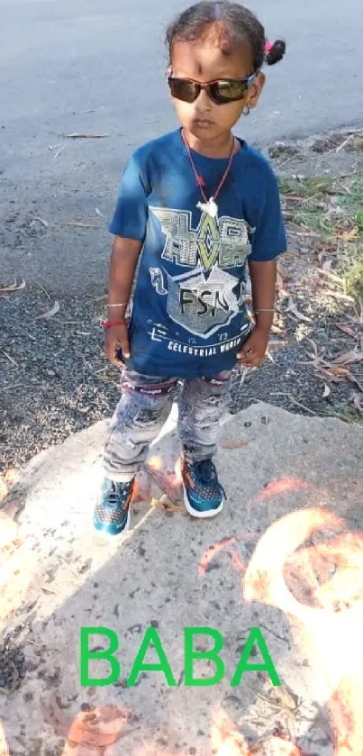 Young child in sunglasses posing outdoors.