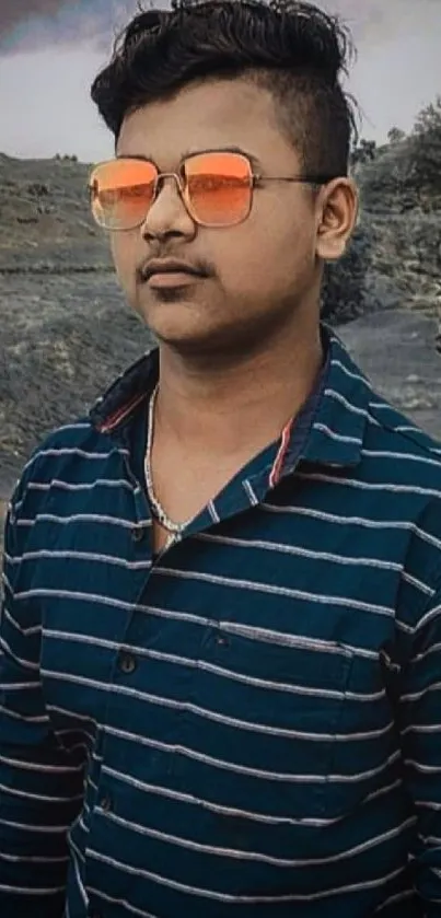 Stylish portrait of a young man with sunglasses in a scenic landscape.