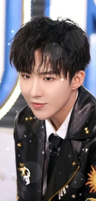 Person in a black leather jacket with gold accents, posing stylishly.