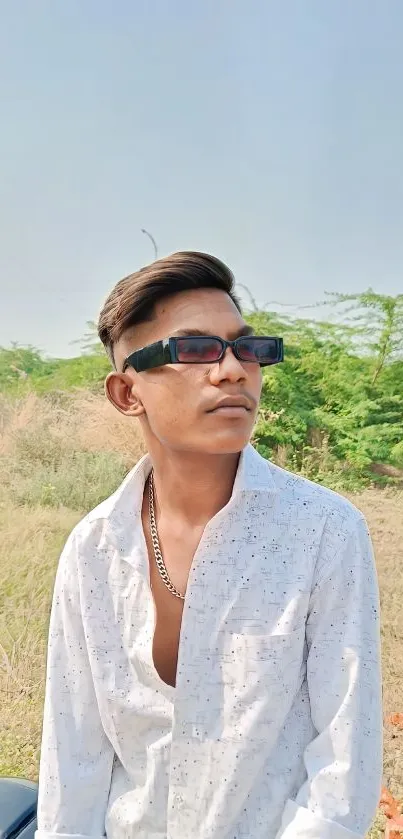 Young man in sunglasses with nature background.