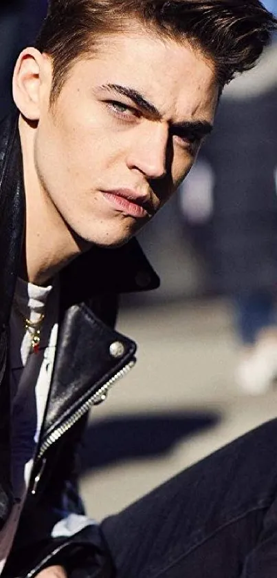 Stylish young man in leather jacket close-up.