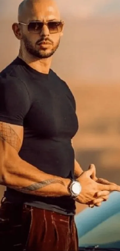 Man wearing sunglasses standing beside a car in a desert setting.