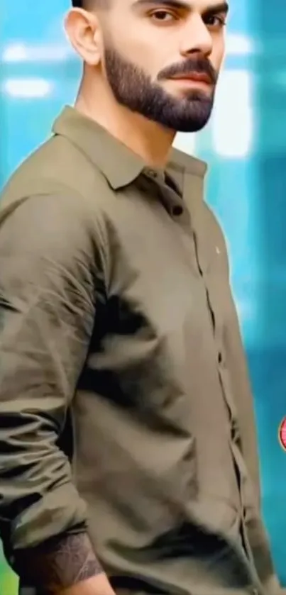 Man in green shirt with blue background.