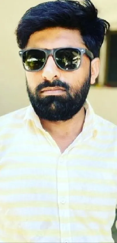 Mobile wallpaper of a stylish man in sunglasses and a light shirt.