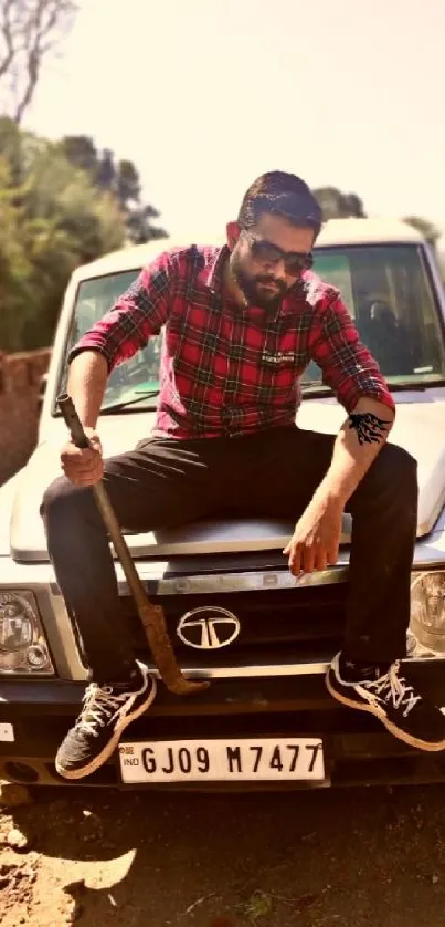 Man sitting confidently on a car hood outdoors.