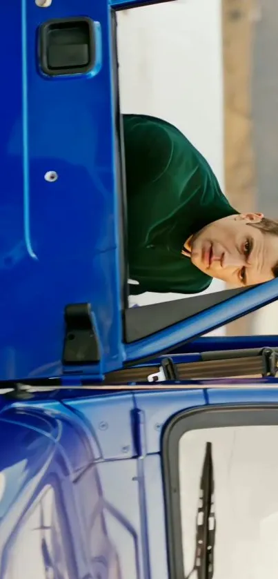 Man leaning on a blue car with a stylish pose.